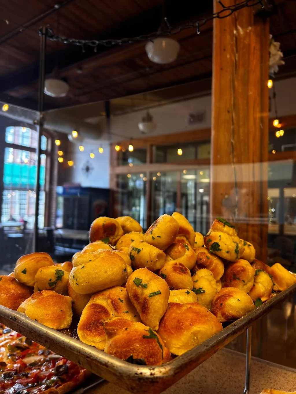 Tray of golden baked dough bites inside the restaurant