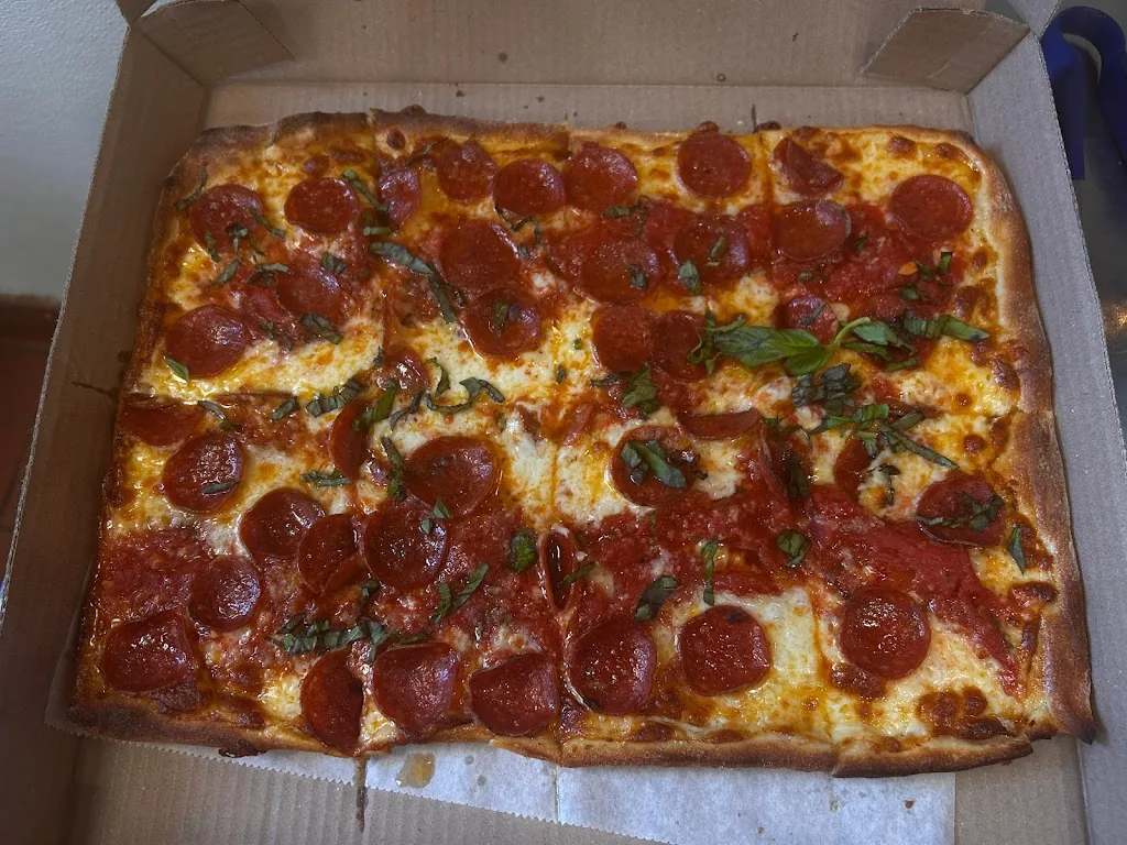 Rectangular pepperoni pizza topped with basil