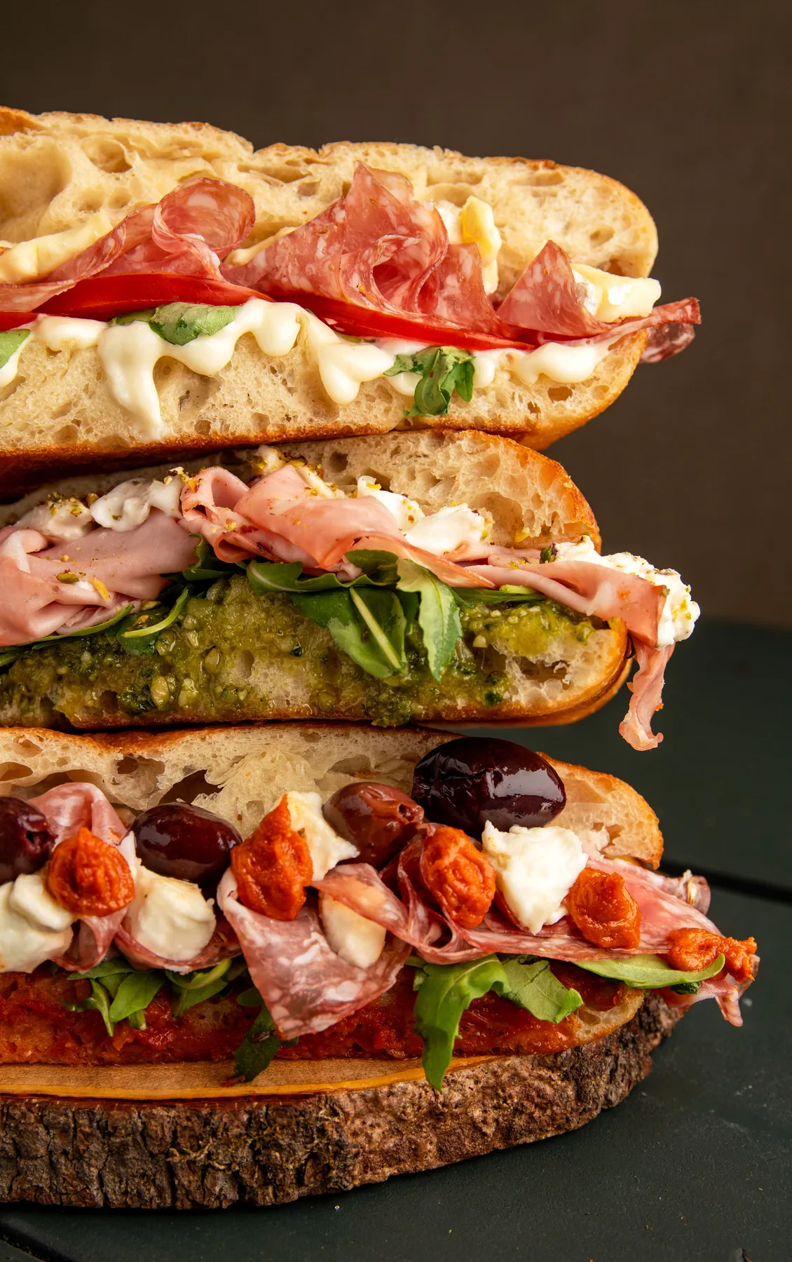 Italian sub sandwiches arranged on a wooden board